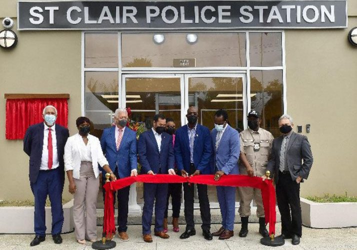 Prime Minister Dr Keith Rowley, fourth from right—in the company of ministers, acting Commissioner of Police McDonald Jacob, second right, Port of Spain Mayor Joel Martinez, third from left, and officials from the Urban Development Corporation of Trinidad and Tobago—cuts the ribbon to officially open the new St Clair Police Station at Serpentine Road, St Clair