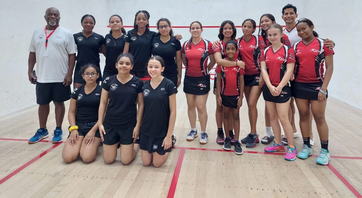 Guyana’s Girls Team (left) posing with T&T Girls Team before their matches