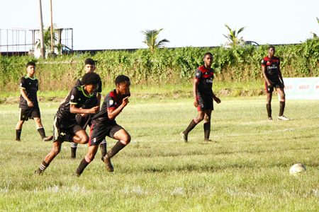 Scenes from the Christianburg (red/black) and Cummings Lodge clash in the quarterfinal section of the Milo Secondary Schools Football Championship at the Ministry of Education ground, Carifesta Avenue