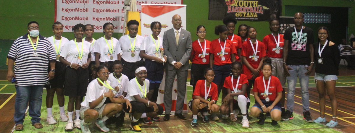 The Out of Town (left), and GT/Demerara All-Stars teams pose with their medals following the conclusion of the girls’ fixture Saturday night.