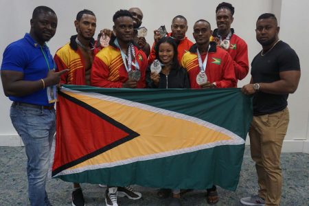 Guyana’s bodybuilding contingent pose with their hardware following the 49th edition of the CAC Championships which was staged over the weekend in Barbados.