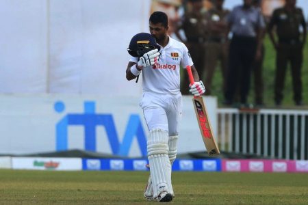 Dinesh Chandimal takes off his helmet and soaks up the applause after  reaching three figures yesterday.
