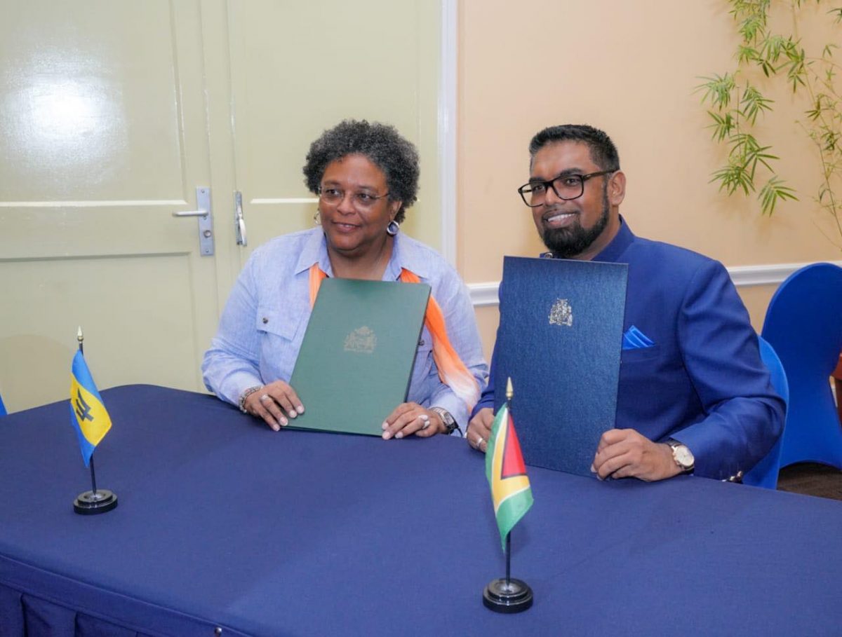 President Irfaan Ali (right) Prime Minister Mia Mottley after the signing of the accord. (Office of the President photo)