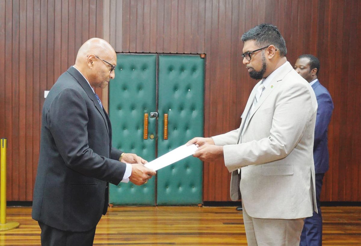 Conrad Enill (left) presenting his Letters of Credence to President Irfaan Ali (Office of the President photo)