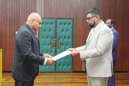 Conrad Enill (left) presenting his Letters of Credence to President Irfaan Ali (Office of the President photo)