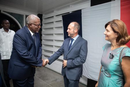 Prime Minister Mark Phillips (left) greeting Chargé d’Affaires of the French Embassy to Guyana and Suriname, José Gomez on Monday. (Department of Public Information photo)
