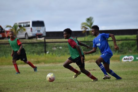 Scenes from the Golden Grove (blue) and Friendship quarter-final clash in the Milo Secondary Schools Football Championships yesterday.