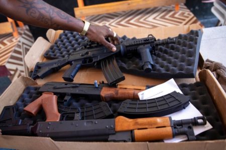 A G9 gang coalition member unpacks weapons in Port-au-Prince, Haiti, Oct. 6, 2021. A confrontation thought to be between the G9 and the GPEP gangs has led to dozens of deaths since July 8, 2022.