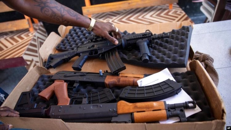 A G9 gang coalition member unpacks weapons in Port-au-Prince, Haiti, Oct. 6, 2021. A confrontation thought to be between the G9 and the GPEP gangs has led to dozens of deaths since July 8, 2022.