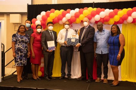 Minister of Health Dr Frank Anthony (fourth from right)  and PAHO/WHO Representative to Guyana, Dr Luis Codina (third from right) at the launching. (Ministry of Health photo)