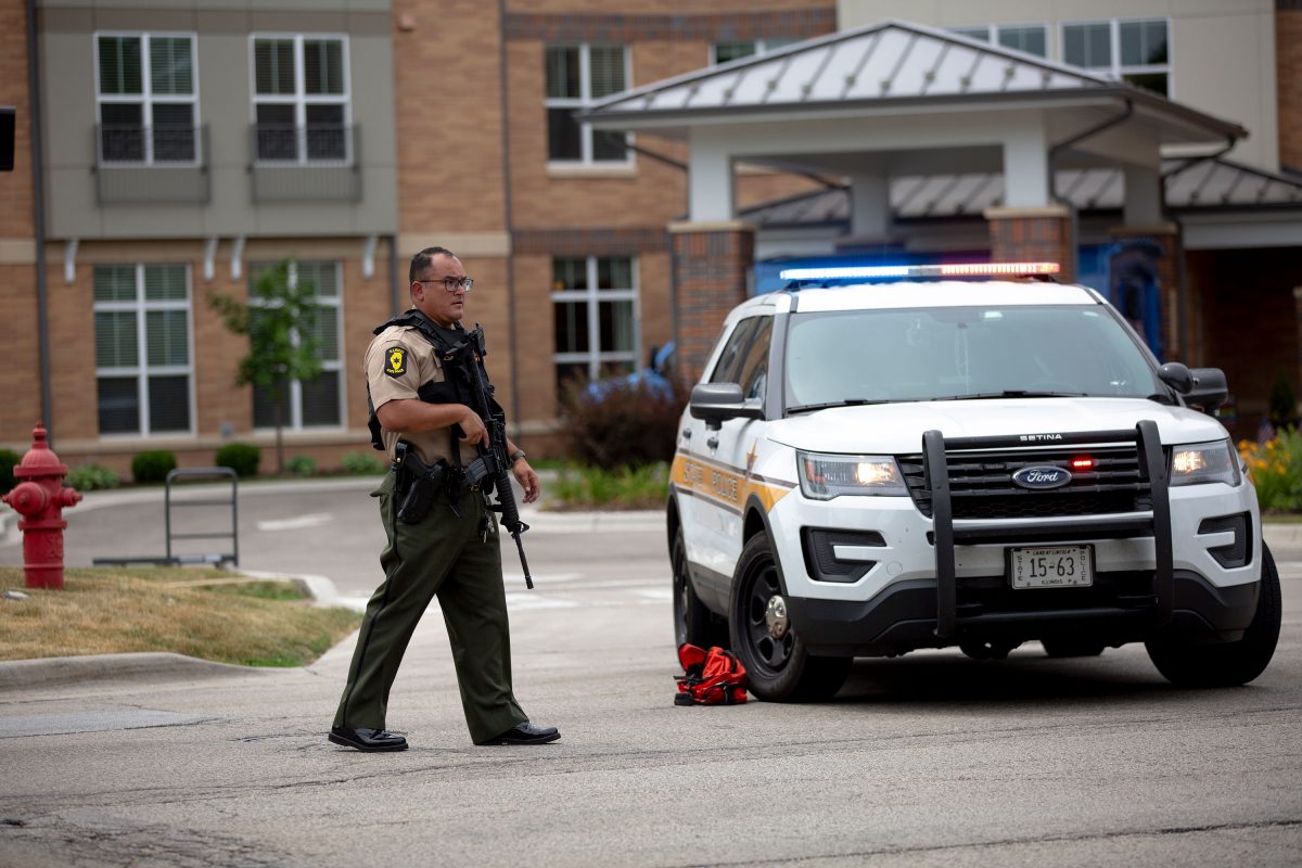 HIGHLAND PARK, IL - JULY 04: First responders work the scene of a shooting at a Fourth of July parade on July 4, 2022 in Highland Park, Illinois. Reports indicate at least five people were killed and 19 injured in the mass shooting. (Photo by Jim Vondruska/Getty Images)