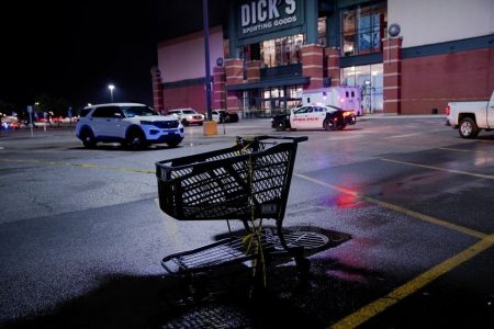 A crime scene tape is seen tied to a shopping cart after a shooting at a mall in the Indianapolis suburb of Greenwood, Indiana, US July 17, 2022. REUTERS 