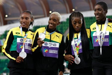 Jamaica’s 4x400m silver medalists Stephenie Ann McPherson, Candice McLeod, Charokee Young, and Janieve Russell on the podium. 