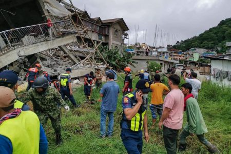 This handout photo taken from the Facebook page of La Trinidad Municipal Police Station shows a rescue team at the site of a collapsed building in La Trinidad, in the province of Benguet on July 27, 2022, after a 7.0-magnitude earthquake hit the northern Philippines. (AFP/La Trinidad Municipal Police Station)
