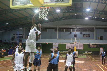 Ezequiel Saul of President’s College in the process of scoring against North Georgetown during their U16 boys divisional clash in the ExxonMobil NSBF at the Cliff Anderon Sports Hall last evening.