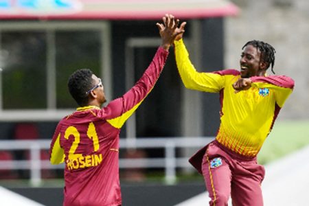  Akeal Hosein (left) and Hayden Walsh celebrate a wicket during yesterday’s first Twenty20 International. (Photo courtesy CWI Media) 