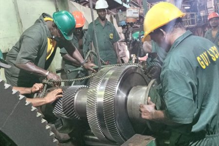 GuySuCo’s engineers installing the new gear in the turbine at Uitvlugt Estate factory (GuySuCo photo)