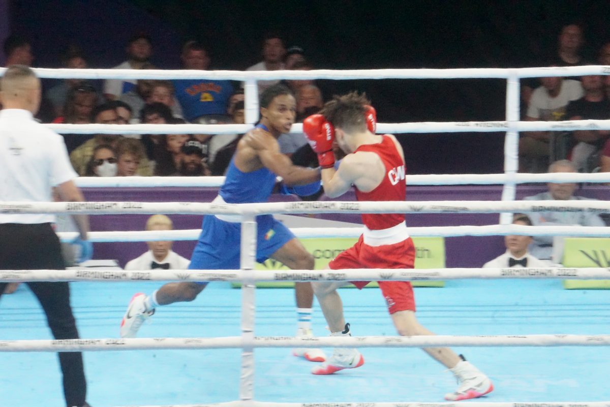 Keevin Allicock (blue) in action against his quarterfinal Canadian opponent, Keoma Ali Al Ahmadieh. Allicock lost a split decision duel and exited the Games. (Emmerson Campbell photo)
