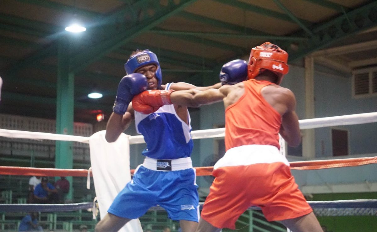 Shakquain James (right) lands a stiff jab to the chin of his Bahamian opponent, Keano Cox. James went on to win the fight after a second round stoppage. (Emmerson Campbell photo)