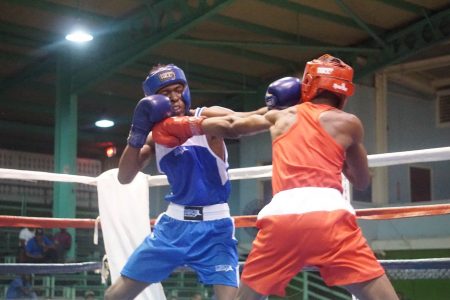 Shakquain James (right) lands a stiff jab to the chin of his Bahamian opponent, Keano Cox. James went on to win the fight after a second round stoppage. (Emmerson Campbell photo)