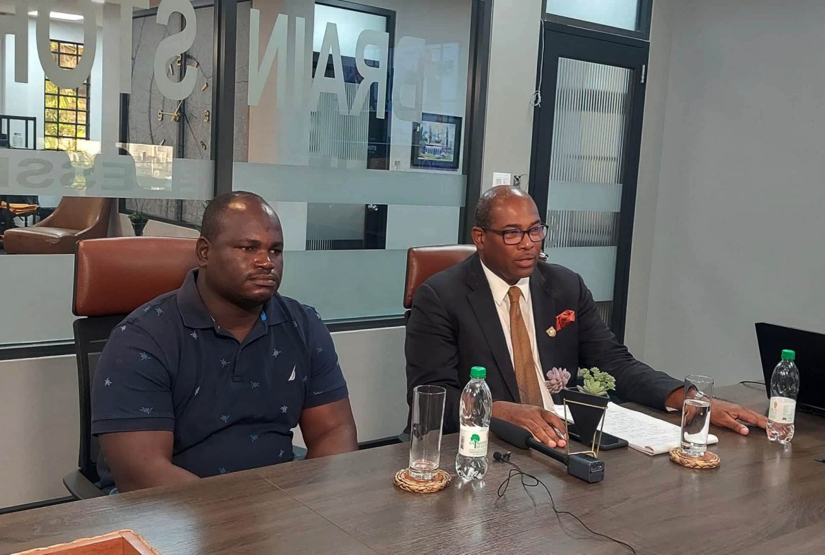 Police Sergeant Dion Bascom with his lawyer, Nigel Hughes, at yesterday’s press conference 