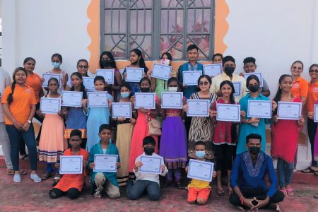 Youths posing with their certificates of participation