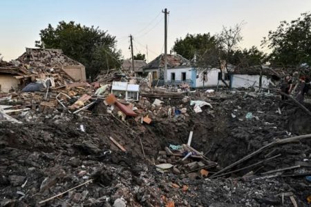 People stand next to a residential house destroyed by a Russian military strike, as Russia's attack on Ukraine continues, in Chaplyne, Dnipropetrovsk region, Ukraine, on Aug 24, 2022. (Photo: REUTERS/Dmytro Smolienko) 
