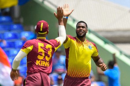  Obed McCoy (right) celebrates a wicket with Brandon King during his record six-wicket haul on Monday. (Photo courtesy CWI Media) 