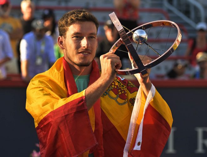 Carreno Busta poses with the championship trophy after defeating Hubert Hurkacz to win the Canadian Masters
