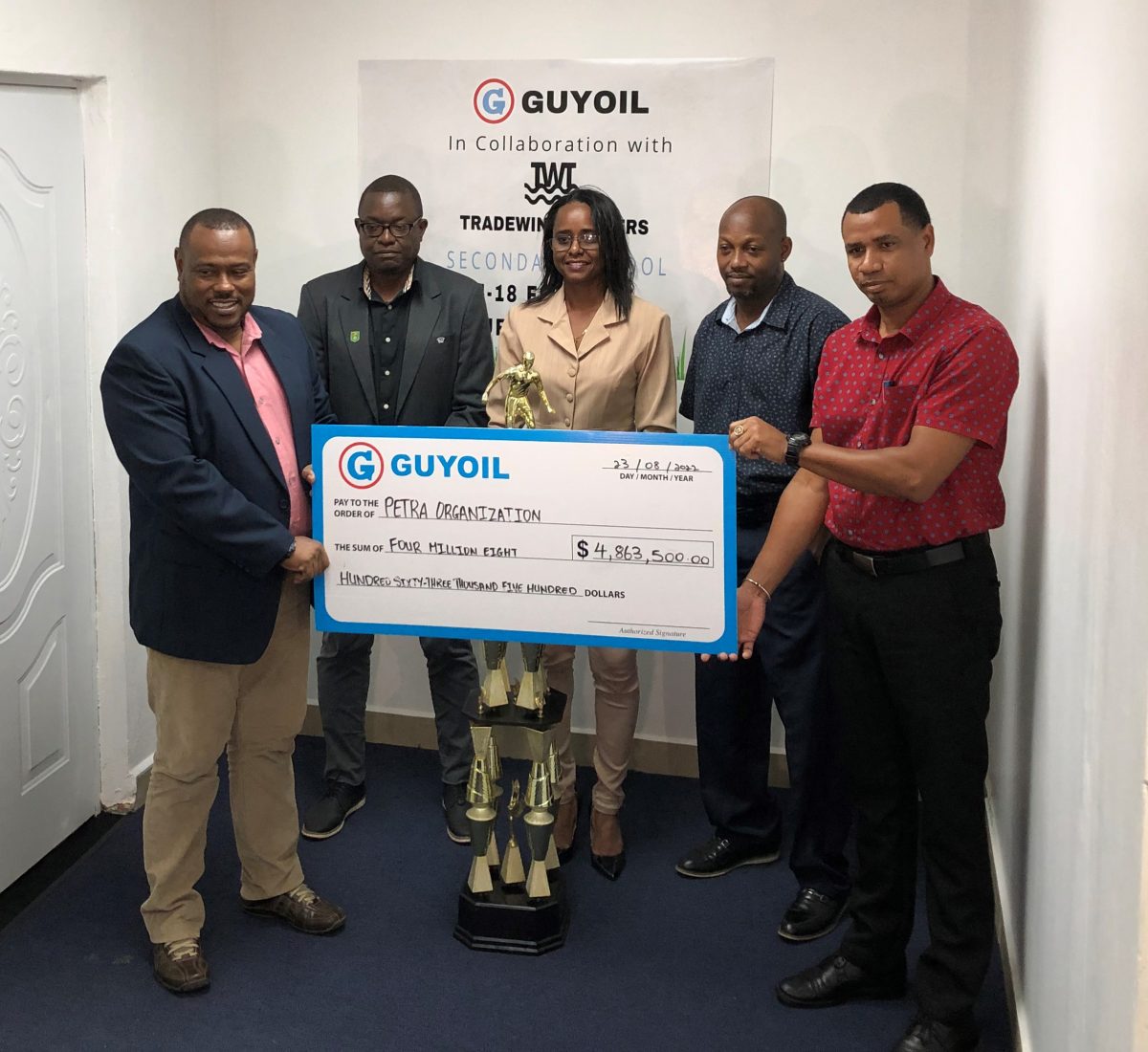 Petra Organization Co-Director, Troy Mendonca (left) receiving the sponsorship cheque from GUYOIL Bulk Sales Executive, Berkeley McCalman, in the presence of Assistant Director of Sport, Melissa Richardson, (centre), GFF Technical Director, Bryan Joseph (2nd from left), and Head of the Physical Education Department at the Ministry of Education, Kirk Brathwaite

