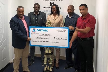 Petra Organization Co-Director, Troy Mendonca (left) receiving the sponsorship cheque from GUYOIL Bulk Sales Executive, Berkeley McCalman, in the presence of Assistant Director of Sport, Melissa Richardson, (centre), GFF Technical Director, Bryan Joseph (2nd from left), and Head of the Physical Education Department at the Ministry of Education, Kirk Brathwaite
