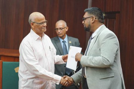Clement Rohee (left) receives his instrument of appointment from President Irfaan Ali (Office of the President photo)
