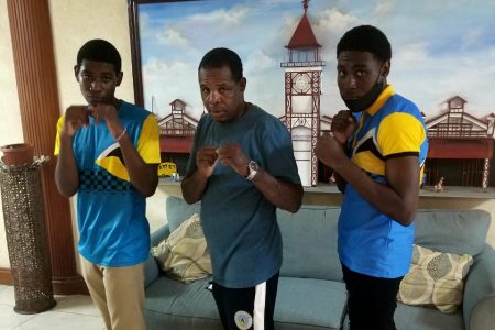 St Lucia head-coach Conrad Fredericks (centre) is flanked by boxers Herve Charlemagne (left) and Kevert Similien following their arrival on local shores
