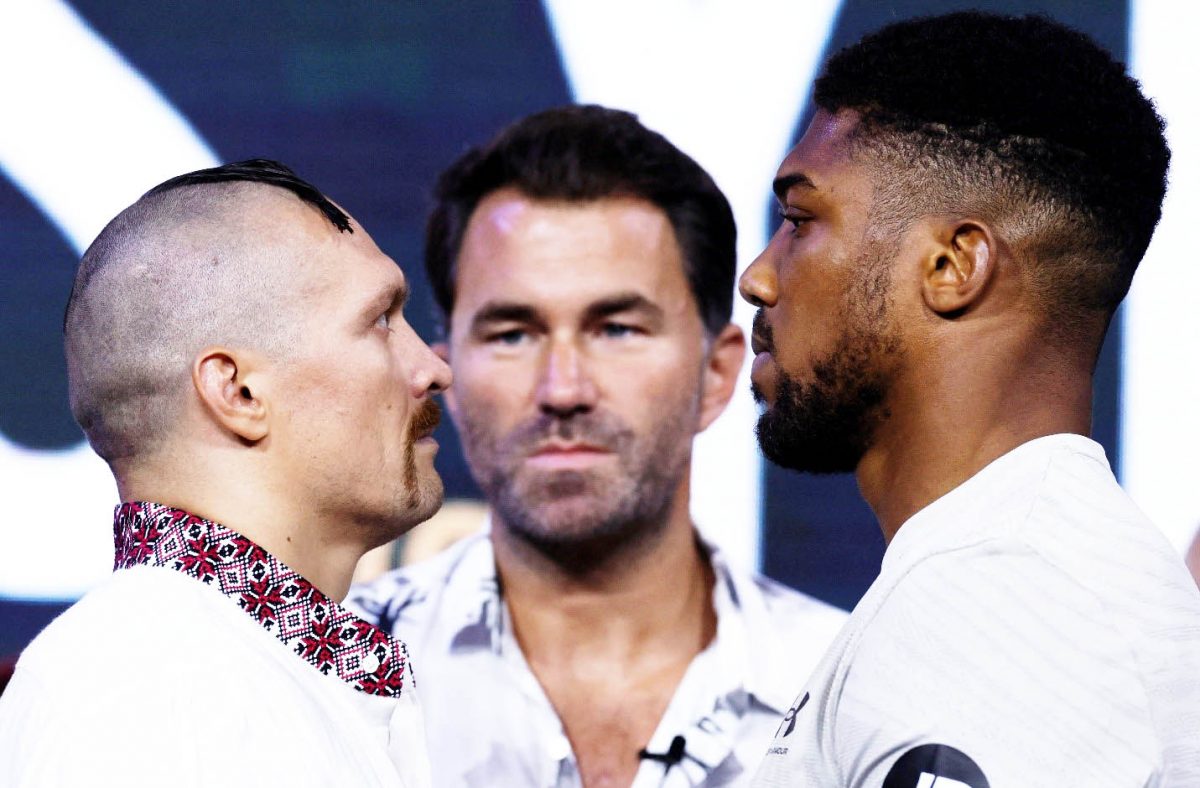 Oleksandr Usyk (left) and Anthony Joshua go head to head during the weigh-in as promoter Eddie Hearn looks on Action Images via Reuters/Andrew Couldridge