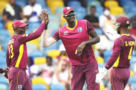 Shamarh Brooks (left) of the West Indies celebrating with teammates Jason Holder (centre) and Shai Hope following the dismissal of New Zealand’s Devon Conway
