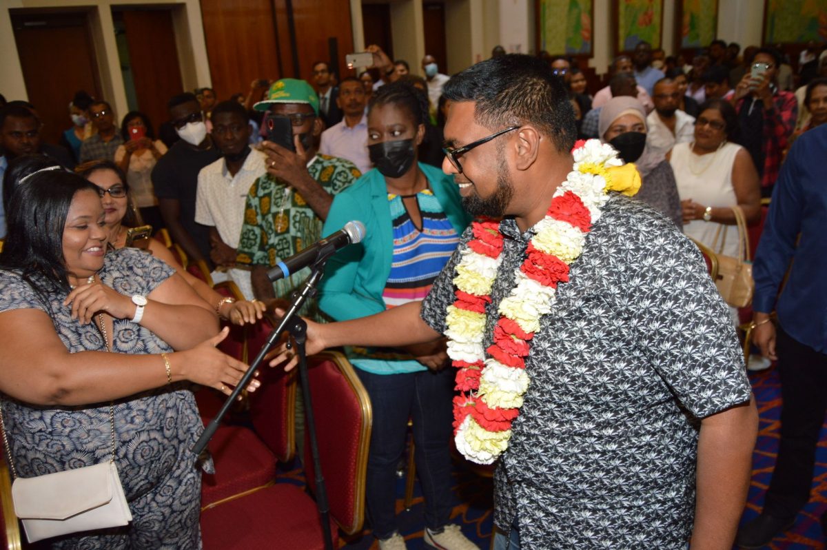 Guyana President Mohamed Irfaan Ali (right) greets Guyanese living in Trinidad during the Guyana Diaspora Outreach held at the Radisson Hotel, Port-of-Spain, on Saturday.