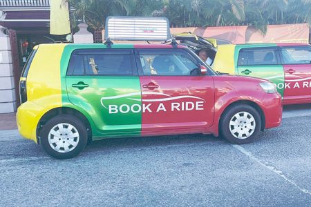 One of the promotional Book-A-Ride vehicles equipped with a billboard at the launch