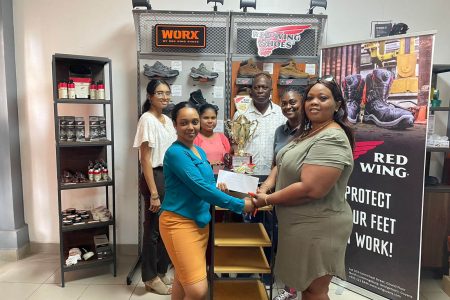 Charlyn Barnwell receives the third placed trophy with medals and sponsorship cheque from Sales Executive, Kerisha Beete while other sales executives, Houshadi Arjune, Lisa Ganesh, Customs Manager, Yoletta Bynoe, and Organiser Roderick Harry, savour the moment.