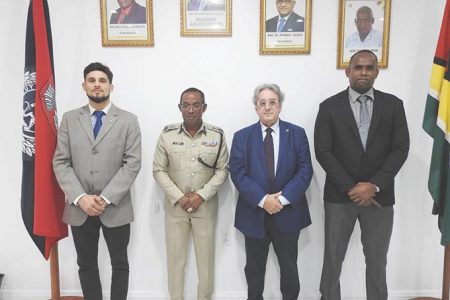 Commissioner of Police (ag) Clifton Hicken (second from left) and Crime Chief Wendell Blanhum (right) with the INTERPOL officials. (Police photo)