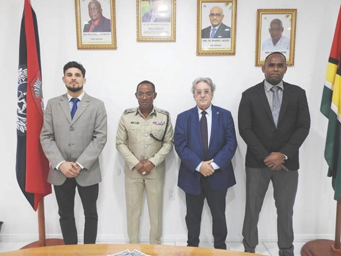 Commissioner of Police (ag) Clifton Hicken (second from left) and Crime Chief Wendell Blanhum (right) with the INTERPOL officials. (Police photo)