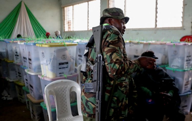 A police officer walks next to sealed ballot boxes containing electoral materials at an Independent Electoral and Boundaries Commission (IEBC) tallying centre after the general election in Nairobi, Kenya August 11, 2022. REUTERS/Thomas Mukoya