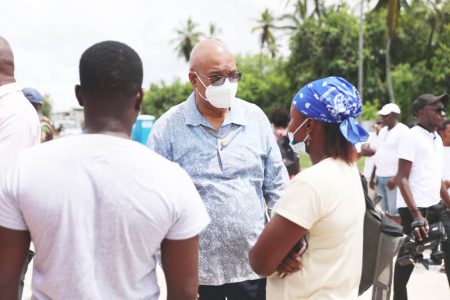 Minister of Public Works,  Juan Edghill (centre) in discussion with residents. (Ministry of Public Works photo)
