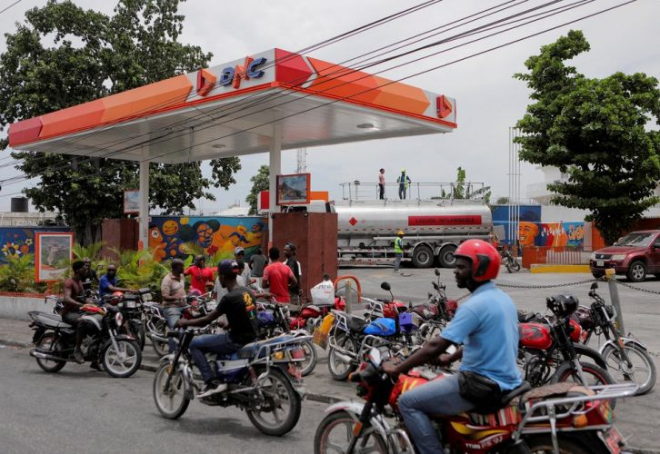 People wait outside a petrol station as Haiti's main fuel terminal renewed deliveries that had been suspended due to an outbreak of gang violence, in Port-au-Prince, Haiti July 14, 2022. REUTERS/Ralph Tedy Erol