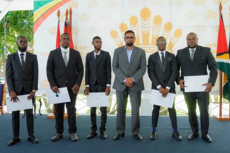President Irfaan Ali (third from right) with the surveyors. (Office of the President photo)
