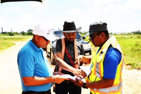 From left: Minister of Housing and Water, Collin Croal; CHPA Director of Projects,  Omar Narine and CHPA Civil Engineer,  Randolph Hunte examining the site map. (CHPA photo)