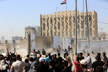 Iraqi Shiite gunmen loyal to Shiite cleric and Sadrist movement leader Muqtada al-Sadr, destroy a security wall as they clash with government forces backed by armed Shiite groups in the governmental area of Green Zone in central Baghdad, Iraq, 30 August 2022. At least 23 people were killed and hundreds were injured since clashes erupted on 29 August following al-Sadr's announcement to withdraw from politics. Al-Sadr has on 30 August held a press conference where he disavowed the overnight violence and gave his supporters 60mn to leave the green zone area. EPA-EFE/AHMED JALIL