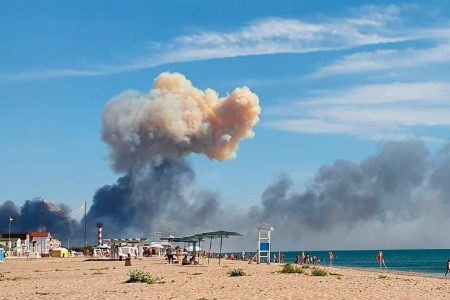 Rising smoke can be seen from the beach at Saky after explosions were heard from the direction of a Russian military airbase near Novofedorivka, Crimea, Tuesday Aug. 9, 2022. The explosion of munitions caused a fire at a military air base in Russian-annexed Crimea Tuesday but no casualties or damage to stationed warplanes, Russia's Defense Ministry said. (UGC via AP) 