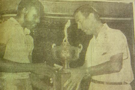 Mervyn Anthony receiving the Guyana national championship trophy