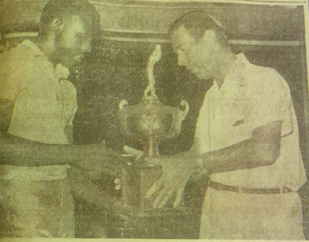 Mervyn Anthony receiving the Guyana national championship trophy