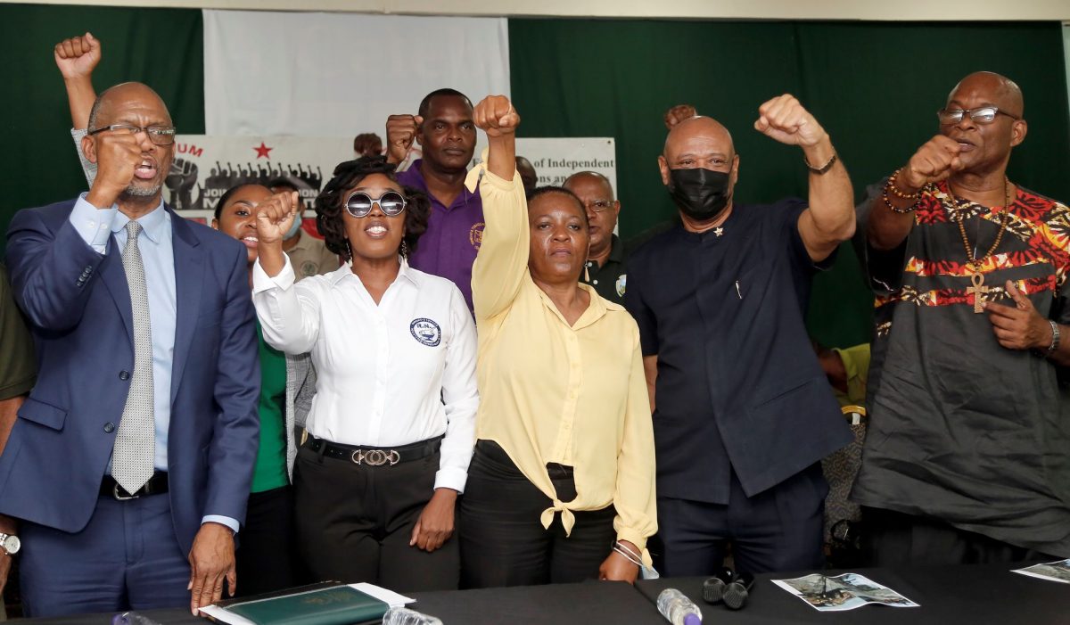 Members of JTUM show a fist of support following the announcement of a massive march on Friday, at a press conference at the PSA Headquarters, Abercromby Street, Port-of-Spain yesterday. From left, president of the PSA Leroy Baptiste, Second President of the RMN, Letitia Cox, President of Contractors and General Workers Trade Union, Nicole Olivierre, President of the OWTU, Ancel Roget and President of the Seamen and Waterfront Workers Trade Union, Michael Annisette.